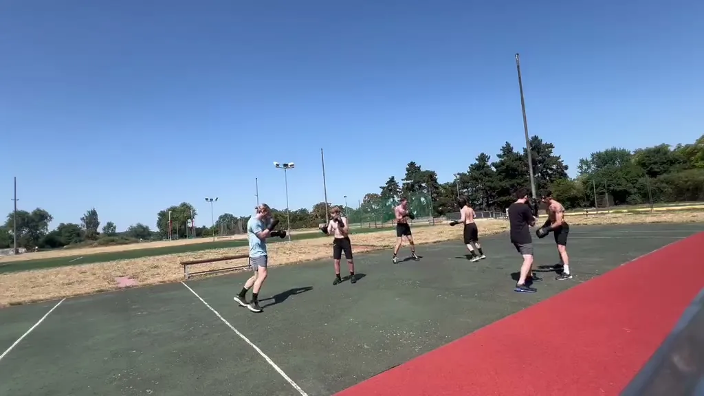 Boxers practising in pairs on the outdoor courts